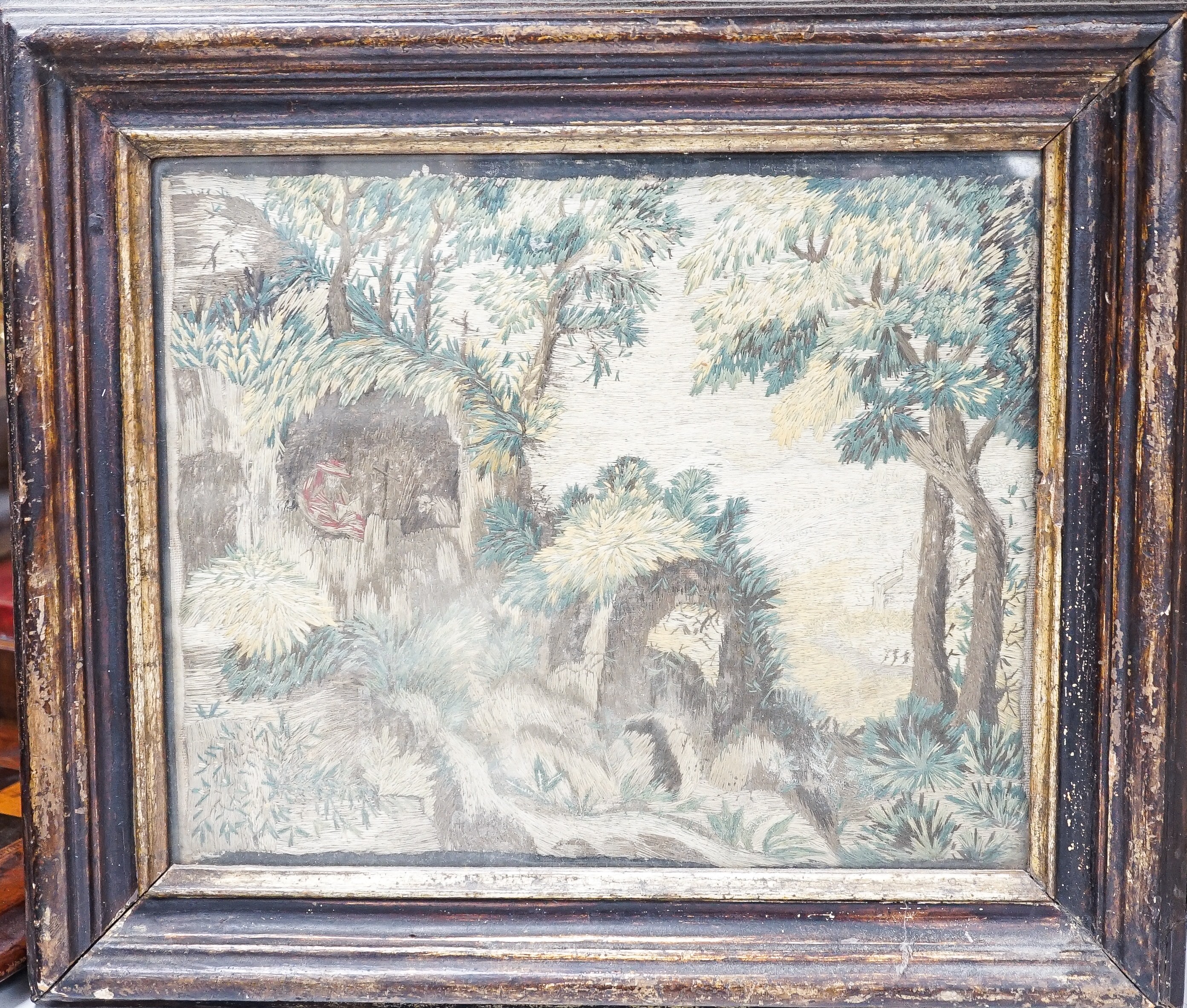 A pair of 18th century wool and silkwork pictures in ebonised frames, 26 cms high x 22 cms wide.